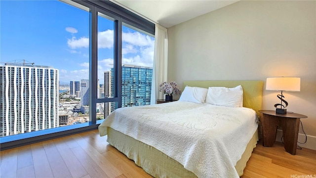 1108 Auahi St Unit 3201, Honolulu, HI 96814 - bedroom featuring floor to ceiling windows, wood finished floors, multiple windows, and a city view