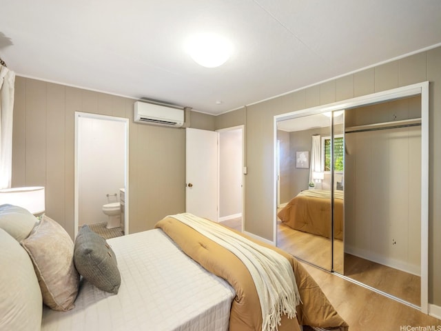 2527 Henry St Unit A, Honolulu, HI 96817 - bedroom with an AC wall unit, wood finished floors, a closet, and ensuite bath