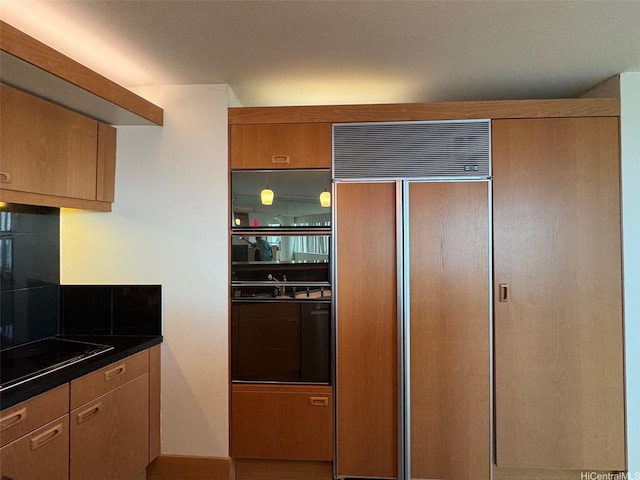 1330 Ala Moana Blvd Unit 2105, Honolulu, HI 96814 - kitchen with black appliances, dark countertops, and brown cabinets