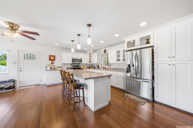 66-342-A Aukai Ln Unit 2, Haleiwa, HI 96712 - kitchen featuring appliances with stainless steel finishes, dark wood-type flooring, a center island, a kitchen breakfast bar, and recessed lighting