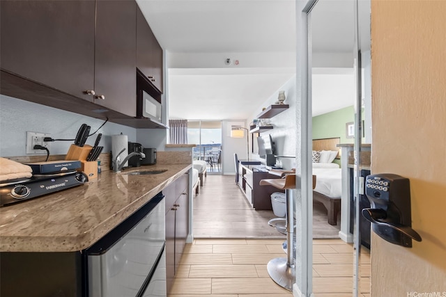 445 Seaside Ave Unit 3203, Honolulu, HI 96815 - kitchen featuring light stone countertops and wood finish floors