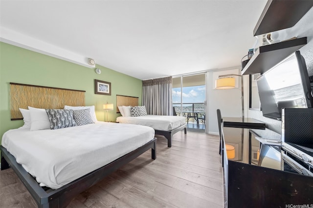 445 Seaside Ave Unit 3203, Honolulu, HI 96815 - bedroom with access to outside, wood finished floors, and floor to ceiling windows