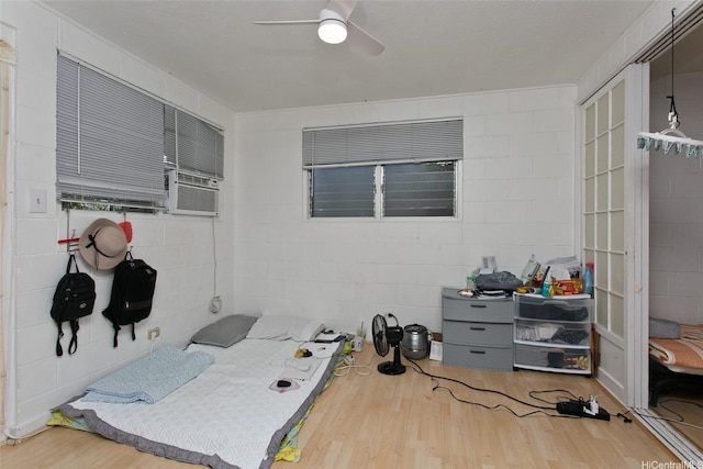1720 Poki St Unit 201, Honolulu, HI 96822 - office space with wood finished floors, ceiling fan, concrete block wall, and cooling unit