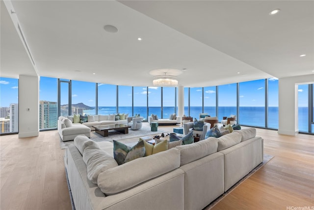 1108 Auahi St Unit 3800, Honolulu, HI 96814 - living area featuring light wood-type flooring, a wall of windows, a water view, and recessed lighting