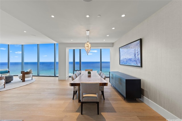 1108 Auahi St Unit 3800, Honolulu, HI 96814 - dining space featuring light wood-style floors, recessed lighting, a chandelier, and a water view