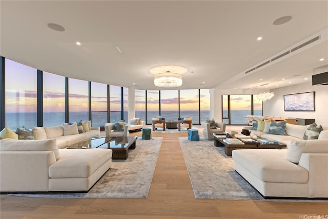 1108 Auahi St Unit 3800, Honolulu, HI 96814 - living room featuring a chandelier, expansive windows, a water view, wood finished floors, and recessed lighting
