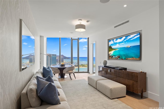 1108 Auahi St Unit 3800, Honolulu, HI 96814 - living area featuring floor to ceiling windows and light wood finished floors