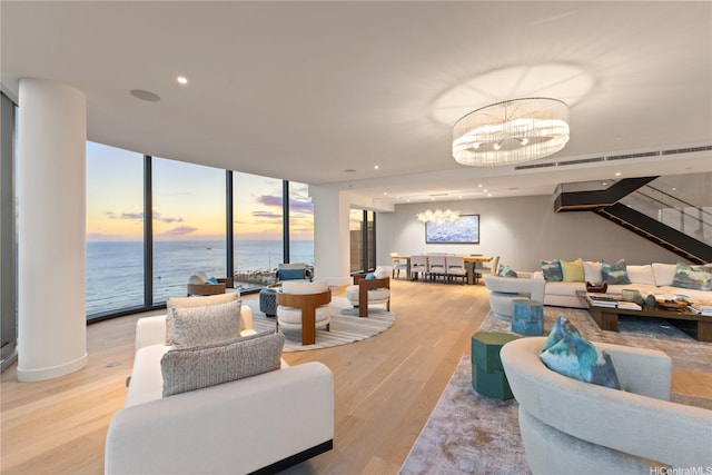 1108 Auahi St Unit 3800, Honolulu, HI 96814 - living area with a chandelier, light wood finished floors, a water view, expansive windows, and recessed lighting