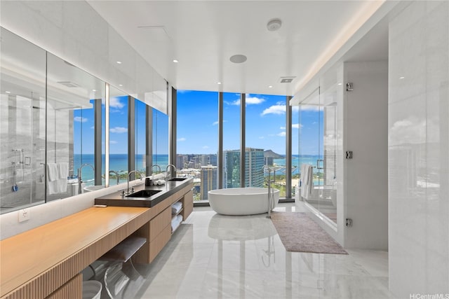 1108 Auahi St Unit 3800, Honolulu, HI 96814 - bathroom with double vanity, a soaking tub, a water view, expansive windows, and a stall shower