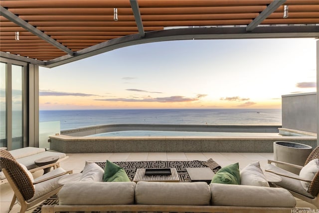 1108 Auahi St Unit 3800, Honolulu, HI 96814 - patio terrace at dusk featuring a balcony, a water view, and an outdoor living space
