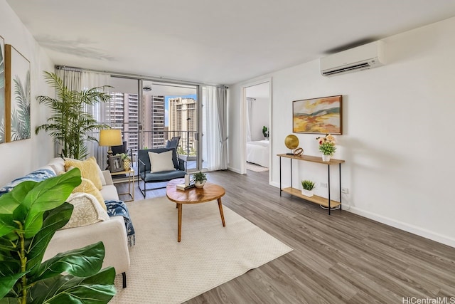 469 Ena Rd Unit 2004, Honolulu, HI 96815 - living room featuring a wall mounted AC, wood finished floors, and baseboards