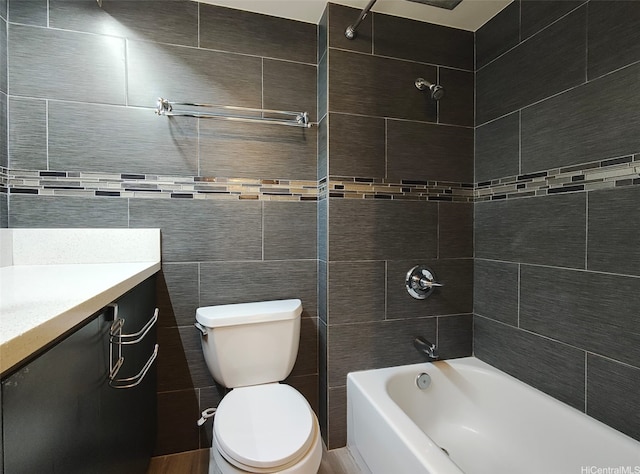 1560 Kanunu St Unit 1316, Honolulu, HI 96814 - bathroom featuring toilet, bathing tub / shower combination, vanity, and tile walls