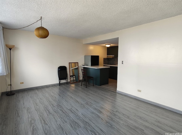 1560 Kanunu St Unit 1316, Honolulu, HI 96814 - living room featuring dark wood-style floors, a textured ceiling, and baseboards