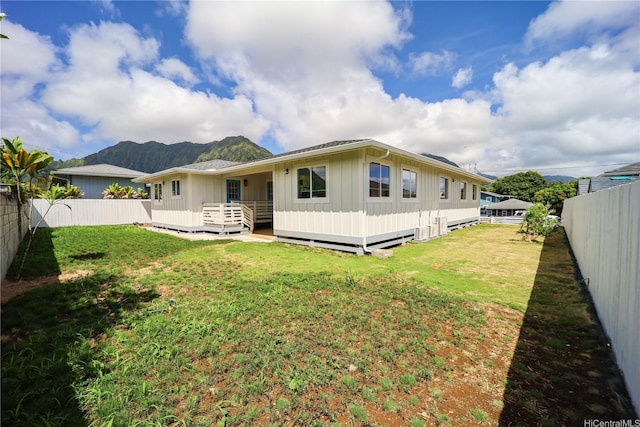 45-420 Pua Makahala St, Kaneohe, HI 96744 - back of house with board and batten siding, a fenced backyard, and a deck with mountain view