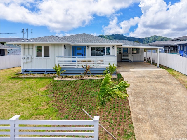 45-420 Pua Makahala St, Kaneohe, HI 96744 - single story home featuring board and batten siding, driveway, an attached carport, roof with shingles, and covered porch