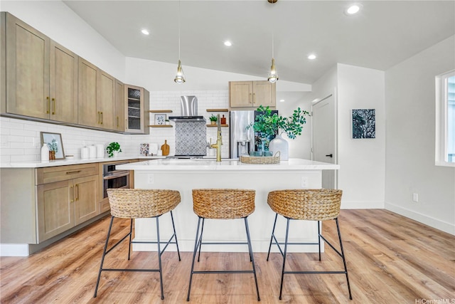45-420 Pua Makahala St, Kaneohe, HI 96744 - kitchen featuring appliances with stainless steel finishes, tasteful backsplash, wall chimney exhaust hood, a breakfast bar area, and light countertops