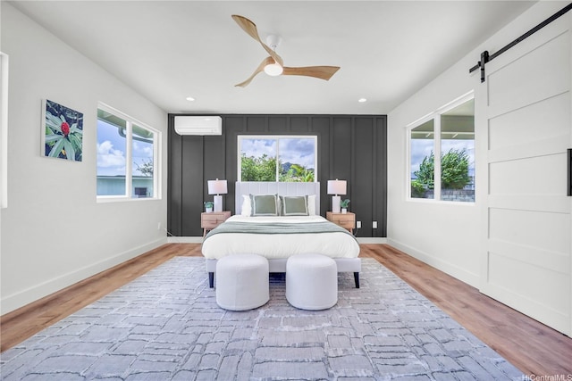 45-420 Pua Makahala St, Kaneohe, HI 96744 - bedroom featuring a wall mounted AC, wood finished floors, a barn door, a ceiling fan, and recessed lighting
