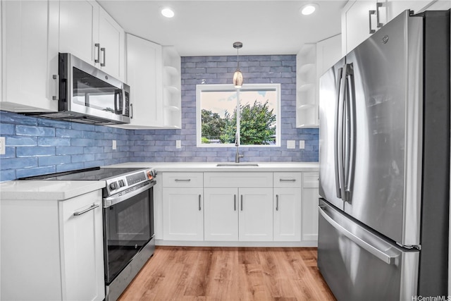 45-420 Pua Makahala St, Kaneohe, HI 96744 - kitchen featuring appliances with stainless steel finishes, open shelves, light countertops, decorative backsplash, and light wood-type flooring