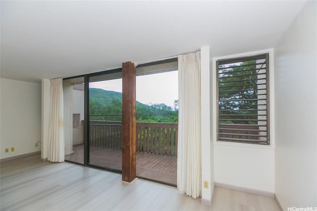84-757 Kiana Pl Unit 6/21A, Waianae, HI 96792 - doorway with light wood finished floors and floor to ceiling windows