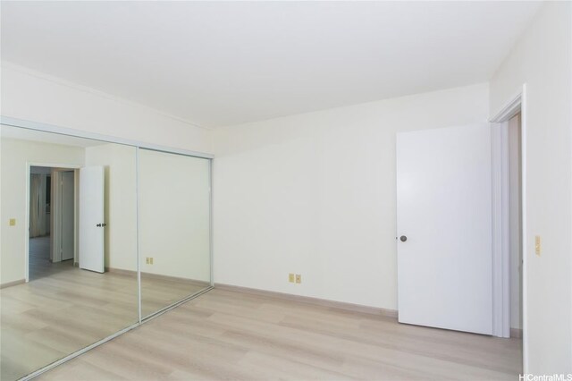84-757 Kiana Pl Unit 6/21A, Waianae, HI 96792 - unfurnished bedroom featuring light wood finished floors and a closet