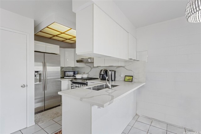 94-1183 Kipaa Pl Unit 14C, Waipahu, HI 96797 - kitchen featuring stainless steel appliances, white cabinetry, a peninsula, and light stone countertops