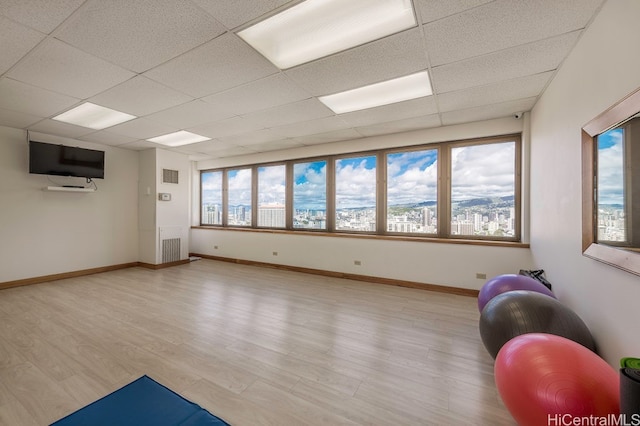 400 Hobron Ln Unit 1609, Honolulu, HI 96815 - exercise area featuring healthy amount of natural light, light wood-style floors, a paneled ceiling, and baseboards