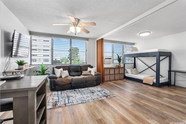 909 Kahuna Ln Unit 305, Honolulu, HI 96826 - living area featuring a textured ceiling, ceiling fan, and wood finished floors