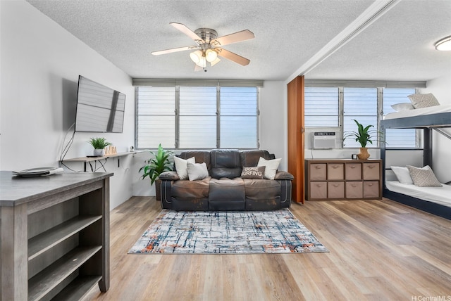 909 Kahuna Ln Unit 305, Honolulu, HI 96826 - living area with a ceiling fan, cooling unit, a textured ceiling, and wood finished floors