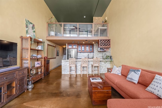 666 Prospect St Unit I502, Honolulu, HI 96813 - living area featuring concrete floors, bar with sink, and a high ceiling