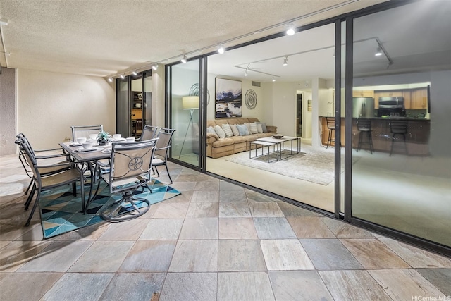 583 Kamoku St Unit Ph7, Honolulu, HI 96826 - dining area featuring track lighting and a textured ceiling