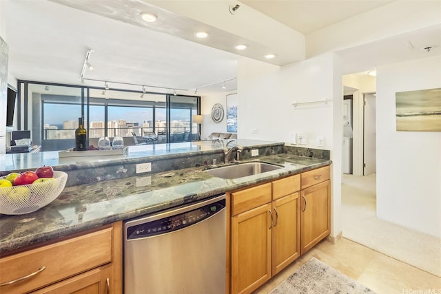 583 Kamoku St Unit Ph7, Honolulu, HI 96826 - kitchen with stainless steel dishwasher, a sink, dark stone countertops, rail lighting, and recessed lighting