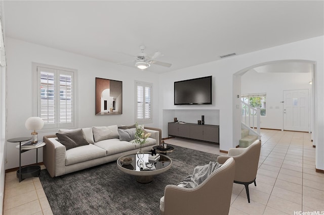 91-1022 Kaikauhaa St, Ewa Beach, HI 96706 - living area featuring light tile patterned flooring, arched walkways, plenty of natural light, and a ceiling fan