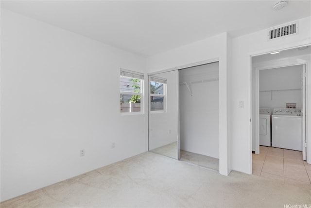 91-1022 Kaikauhaa St, Ewa Beach, HI 96706 - unfurnished bedroom featuring separate washer and dryer, light colored carpet, and a closet
