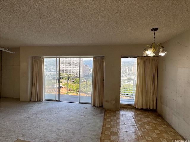 2115 Ala Wai Blvd Unit 1205, Honolulu, HI 96815 - empty room featuring a chandelier and a textured ceiling