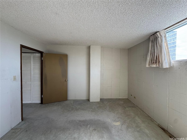 2115 Ala Wai Blvd Unit 1205, Honolulu, HI 96815 - below grade area featuring carpet floors, a textured ceiling, and concrete block wall