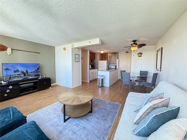 445 Seaside Ave Unit 1120, Honolulu, HI 96815 - living room featuring light wood-type flooring, a ceiling fan, and a textured ceiling