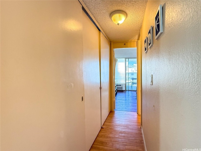 445 Seaside Ave Unit 1120, Honolulu, HI 96815 - hall featuring a textured ceiling and wood finished floors