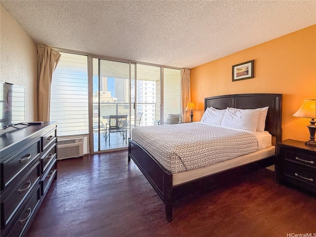 445 Seaside Ave Unit 1120, Honolulu, HI 96815 - bedroom featuring a textured ceiling, access to exterior, a textured wall, dark wood-style flooring, and an AC wall unit