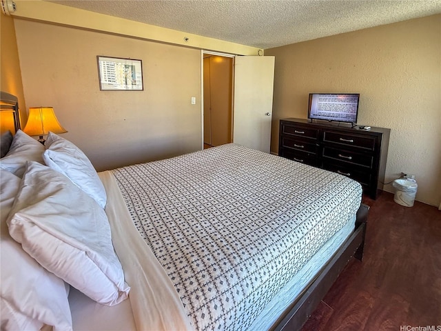 445 Seaside Ave Unit 1120, Honolulu, HI 96815 - bedroom featuring wood finished floors, a textured ceiling, and a closet