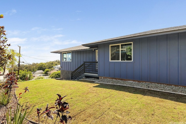 2632 Peter St, Honolulu, HI 96816 - view of front of house featuring board and batten siding, a front lawn, and roof with shingles