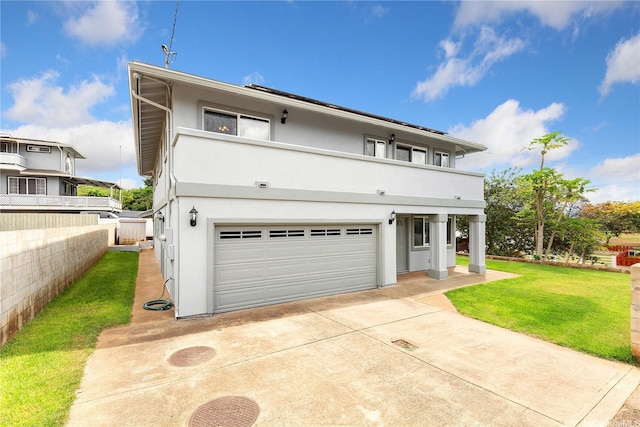 91-2106B Fort Weaver Rd Unit 15, Ewa Beach, HI 96706 - view of front of property with stucco siding, an attached garage, a balcony, and driveway