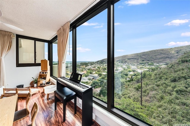 250 Kawaihae St Unit 10E, Honolulu, HI 96825 - sunroom featuring wood finished floors, a textured ceiling, and a mountain view