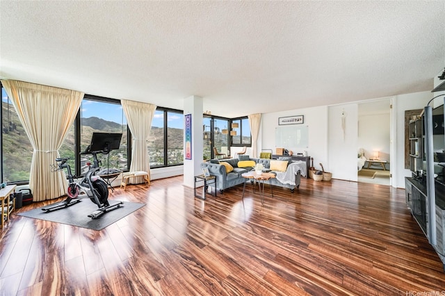 250 Kawaihae St Unit 10E, Honolulu, HI 96825 - living room featuring a textured ceiling and wood finished floors