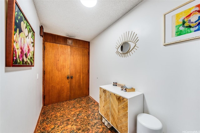 250 Kawaihae St Unit 10E, Honolulu, HI 96825 - hallway featuring a textured ceiling and baseboards