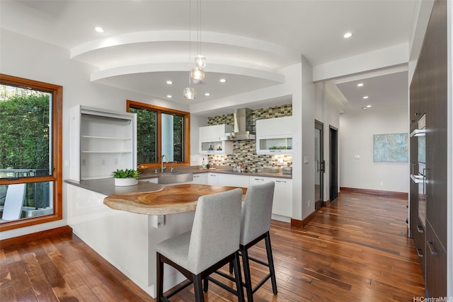 4967 Maunalani Cir Unit B, Honolulu, HI 96816 - kitchen with white cabinets, a sink, wall chimney range hood, recessed lighting, and decorative backsplash