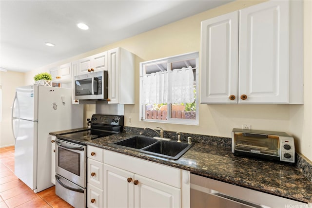 58-292 Kamehameha Hwy, Haleiwa, HI 96712 - kitchen with stainless steel appliances, white cabinetry, dark stone counters, and recessed lighting