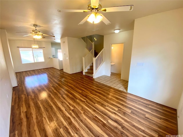 91-1008 Kaiopua St Unit M2, Ewa Beach, HI 96706 - unfurnished living room with wood finished floors, a ceiling fan, and stairs