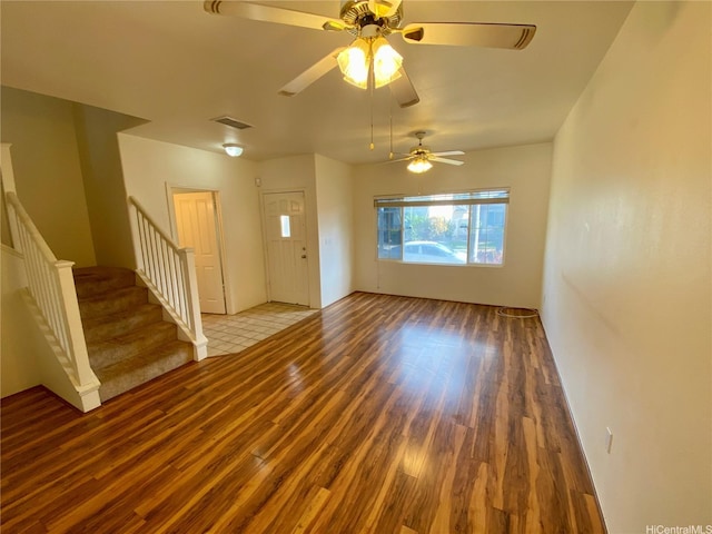 91-1008 Kaiopua St Unit M2, Ewa Beach, HI 96706 - unfurnished living room featuring wood finished floors, stairway, and a ceiling fan