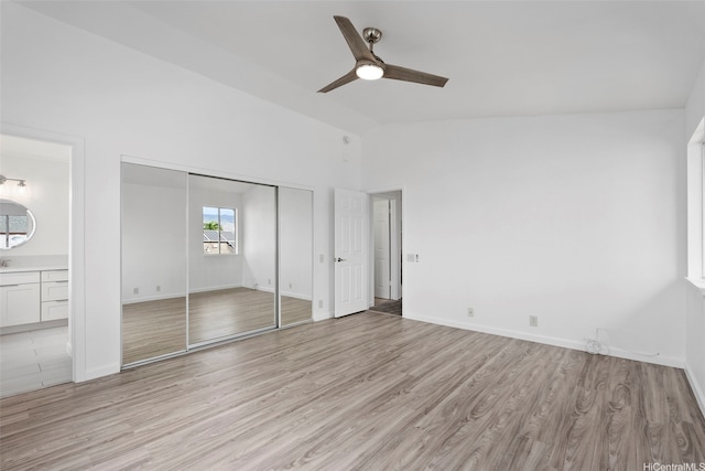 91-1041 Waihuna St, Ewa Beach, HI 96706 - unfurnished bedroom featuring lofted ceiling, light wood finished floors, ensuite bath, a ceiling fan, and a closet