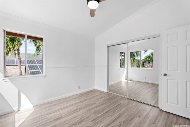 91-1041 Waihuna St, Ewa Beach, HI 96706 - unfurnished bedroom featuring multiple windows, wood finished floors, a closet, vaulted ceiling, and crown molding